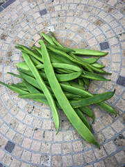 Runner beans on mosaic table top