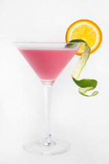 pink cocktail with lime and sliced orange