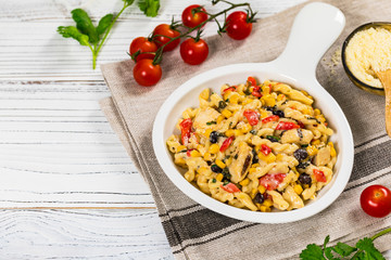 Cheesy Grilled Chicken Alfredo Pasta Florentine with Black Beans and Corn. Selective focus.