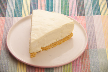 classic cheesecake on white plate on  wooden table