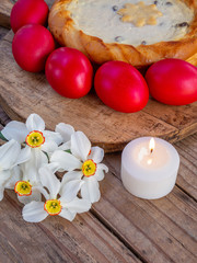 traditional romanian easter dish cozonac and pasca or sweetbread and cheese pie like on wooden table and colored easter eggs and flowers