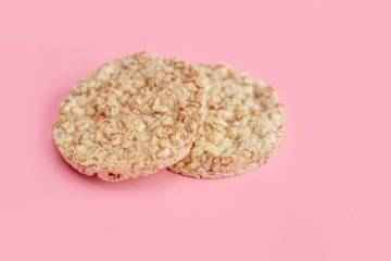 Puffed rice cakes on pink background. Flat lay, top view. Rice waffle on colored background.