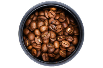 Grains of black coffee in a container on a white background