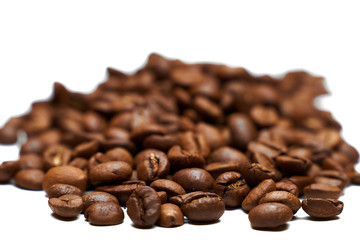 A pile of black coffee grains on a white background