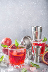 Skinny blood orange basil lemonade cocktail, with fresh bloody oranges, basil leaves and vodka,...