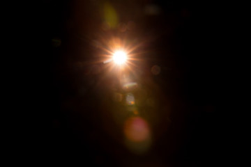 Abstract Natural Sun flare on the black background.