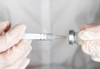 Syringe and vaccine in the hands