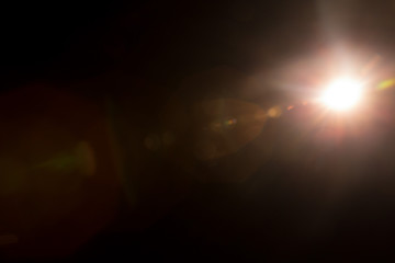 Abstract Natural Sun flare on the black background.