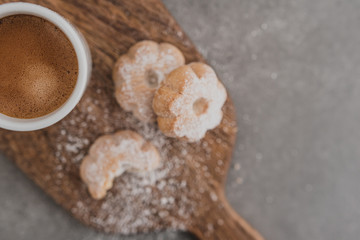 Italian espresso coffee and biscuits on wooden cut board. Selective focus