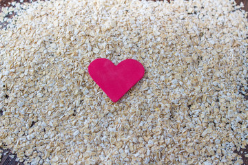 Obraz premium red heart on spilled oats
