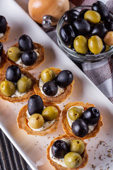 delicious snack tartlets on rustic wooden background