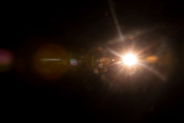 Abstract Natural Sun flare on the black background.