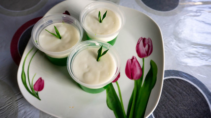 Close up of Som Som Sagu or Sagu Gula Aanau with pandan leaf on a flower plate on table.