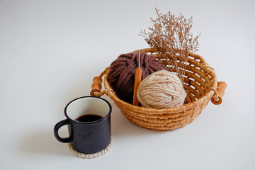 coffee and yarn balls in basket