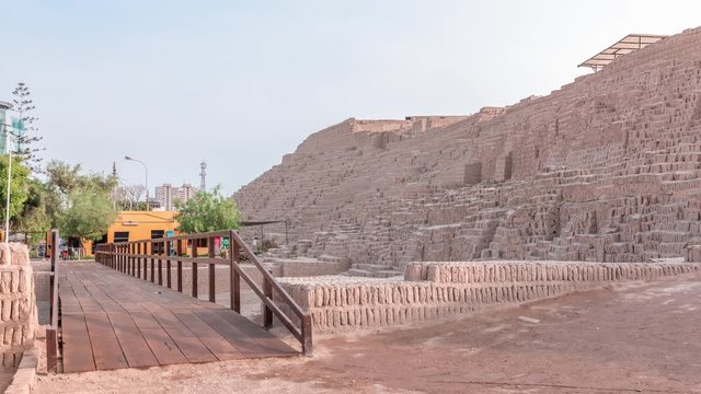 Pyramid of Huaca Pucllana timelapse, pre Inca culture ceremonial building ruins in Lima, Peru. Wooden footbridge and green trees.