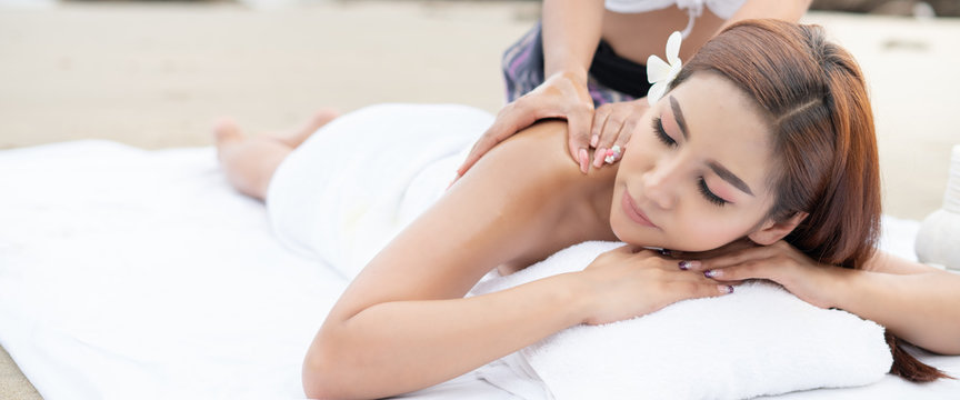 Young asian woman in beach spa.picture of Beautiful woman in spa salon getting massage on the beach in thailand.Spa, resort, beauty and health concept.