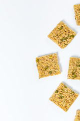 Multigrain Cereal Crunchy Squares Bars with Pumpkin Seeds on Wooden Background. Selective focus.