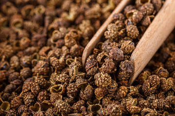fragrant Sichuan pepper on white acrylic background