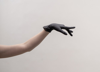 Aesthetic female hand in a black glove.