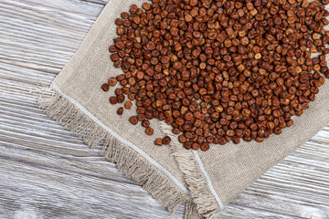 Grey peas on rustic tablecloth and wooden table. Traditional Latvian food, Legumes bean seed.