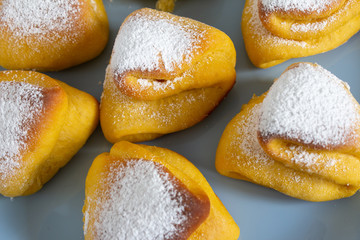 Triangular buns on a blue plate close-up.