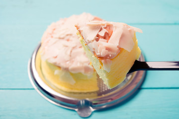 eating fresh cheese cake with chocolate flake on top