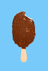 chocolate outer popsicle with a bite on blue background