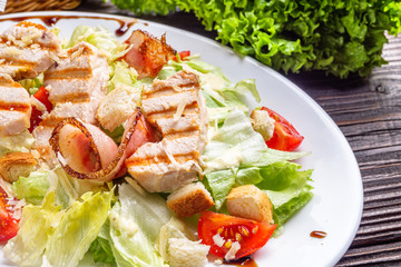 Caesar salad on dark wooden rustic background