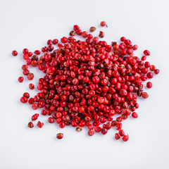 fragrant pink peppercorns on white acrylic background