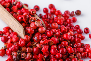 fragrant pink peppercorns on white acrylic background