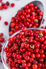 fragrant pink peppercorns on white acrylic background