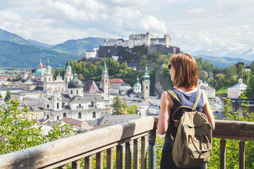 Naklejka premium Holiday in Salzburg: Young girl is enjoying the view. Historic district, Festung Hohensalzburg