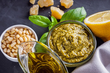 Delicious traditional italian pesto sauce on dark stone background