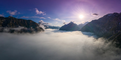above cloud carpet between tirol mountains at lake plansee while sunrise in spring