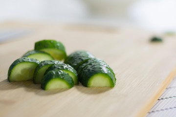 Fresh green cucumber sliced on a cutting board. Healthy eating