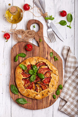 Quiche open tart pie with tomatoes, eggplant and cheese. Galette. Vegetarian dish. Savory taste.