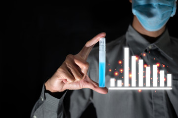 Business man ware mask and hold alcohol for clean bacteria or virus with bad business graph durin covid-19 disease around the world