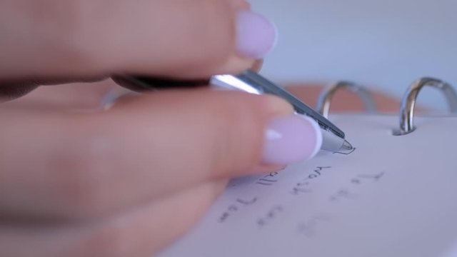 Motivation, management, productivity, success, planning, reminder, goals concept. Woman hand putting mark on check boxes of to do list in personal vintage notebook organizer - close up - slow motion