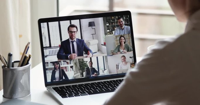 Webcam company team meeting concept. Remote employee conferencing boss and coworkers in online group virtual chat using pc video call app working from home office. Over shoulder laptop screen view - Powered by Adobe