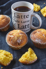 Muffins with coffee on dark background