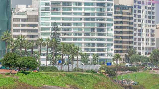Paragliding on a cliff in Parque del Amor or Park of Love in Miraflores district timelapse. Residential buildings on a background. Lima, Peru