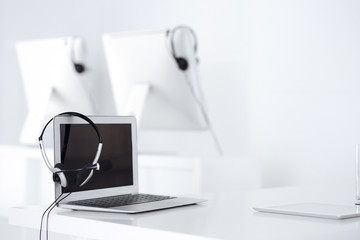Call center and communication support, customer service help desk. VOIP headset on laptop computer