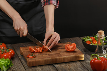 Woman cooking fresh vegetable salad. Female hands. Diet concept for healthy lifestyle with copyspace.