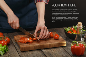 Woman cooking fresh healthy salad. Female hands cutting vegetables on board on wooden table with sample text.