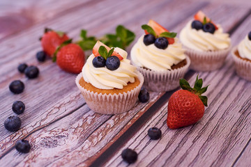 Cupcakes with strawberries and blueberries.