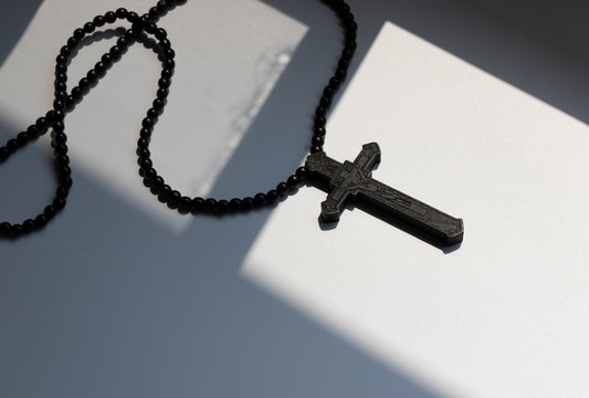 Wood rosary in white background. Brown wooden beads.