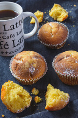Muffins with coffee on dark background