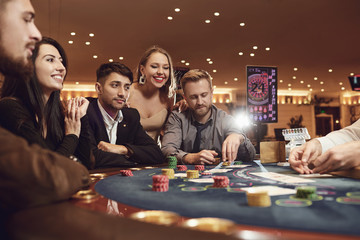 A group of young people gamble at a casino.