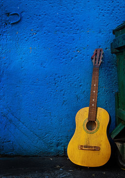 Guitar Against Blue Wall © evgeniy giginyak/EyeEm