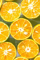 Fototapeta na wymiar The background of fresh oranges, close-up